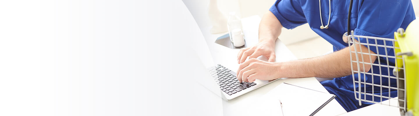 Veterinary professional sitting at laptop