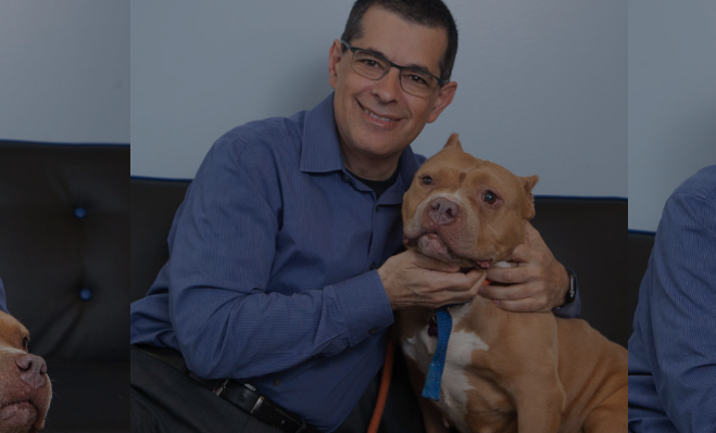 Dr. Joseph Hahn sitting on couch with dog