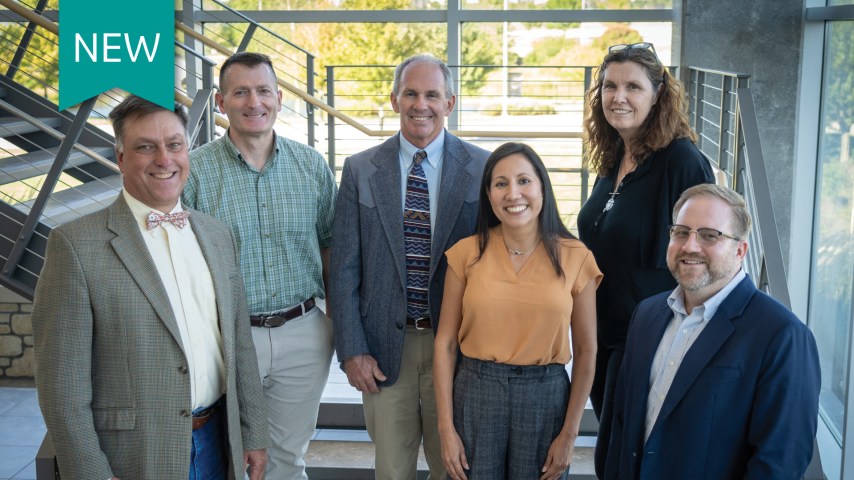 A group of veterinarians stands for a photo.