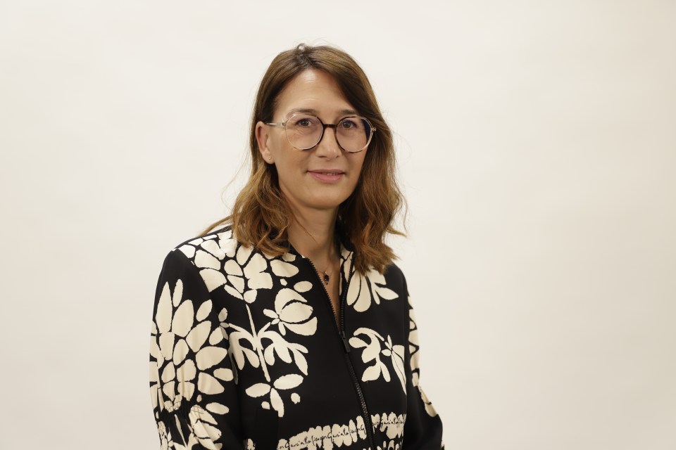 Maria "Chus" Perez wearing a black shirt with a cream colored floral pattern